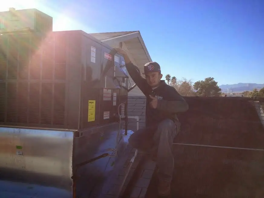 HVAC technician performing HVAC Inspection on a rooftop unit in Little River
